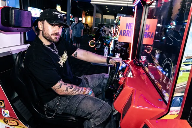NOMOREDEATH at an arcade racing cabinet